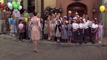Movie still from “The Princess Diaries 2: Royal Engagement” (2004), directed by Garry Marshall – A group of children standing in front of a woman; Wide shot, High angle
