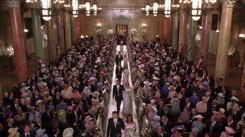 Movie still from “The Princess Diaries 2: Royal Engagement” (2004), directed by Garry Marshall – A group of men and women walking down the aisle of a church; Extreme Wide shot, Overhead angle