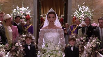 Movie still from “The Princess Diaries 2: Royal Engagement” (2004), directed by Garry Marshall – A woman in a wedding dress standing in front of a group of people; Medium shot, Low angle