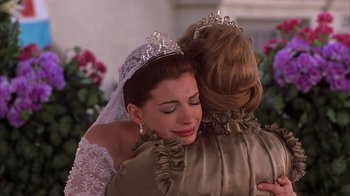 Movie still from “The Princess Diaries 2: Royal Engagement” (2004), directed by Garry Marshall – A woman in a tiara hugging another woman in a dress; Close Up shot, Over the shoulder angle