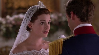 Movie still from “The Princess Diaries 2: Royal Engagement” (2004), directed by Garry Marshall – A man and a woman in wedding attire looking at one another; Close Up shot, Over the shoulder angle