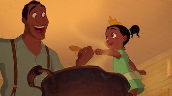 Movie still from “The Princess and the Frog” (2009), directed by Ron Clements – A man and a little girl are eating food together; Medium shot, Overhead angle