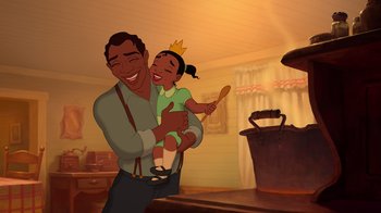 Movie still from “The Princess and the Frog” (2009), directed by Ron Clements – A man holding a little girl in her arms; Medium shot, High angle