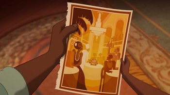 Movie still from “The Princess and the Frog” (2009), directed by Ron Clements – A person holding up a picture of an african - american woman; Extreme Close Up shot, Overhead angle