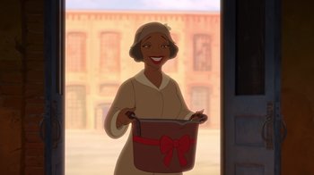 Movie still from “The Princess and the Frog” (2009), directed by Ron Clements – A woman is holding a bucket in front of a building; Wide shot, High angle