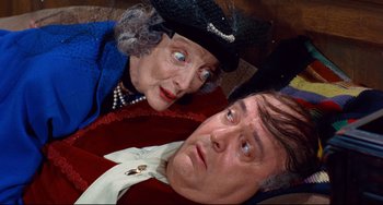 Movie still from “The Producers” (1967), directed by Mel Brooks – An older woman and a younger man are posing for a picture; Close Up shot, Overhead angle