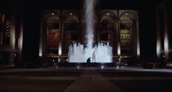 Movie still from “The Producers” (1967), directed by Mel Brooks – Two people standing in front of a fountain at night; Extreme Wide shot, Low angle