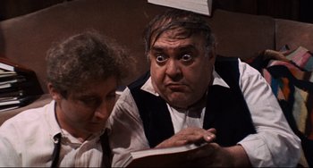 Movie still from “The Producers” (1967), directed by Mel Brooks – A man and a woman are looking at a book; Close Up shot, High angle