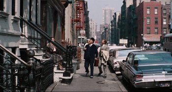 Movie still from “The Producers” (1967), directed by Mel Brooks – Two men walking down the sidewalk of a city street; Wide shot, Low angle