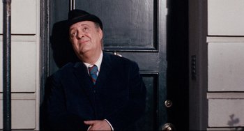 Movie still from “The Producers” (1967), directed by Mel Brooks – An older man wearing a suit and hat; Medium shot, Low angle
