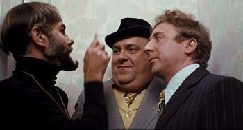 Movie still from “The Producers” (1967), directed by Mel Brooks – A group of men standing next to each other in a room; Close Up shot, Over the shoulder angle