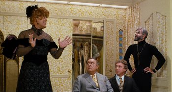 Movie still from “The Producers” (1967), directed by Mel Brooks – A group of people sitting in front of a mirror; Medium shot, Over the shoulder angle