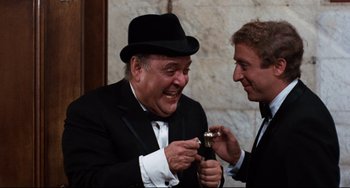 Movie still from “The Producers” (1967), directed by Mel Brooks – A man in a suit and a hat and a man in a suit and a hat; Close Up shot, High angle