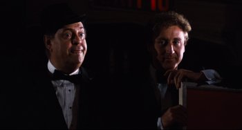 Movie still from “The Producers” (1967), directed by Mel Brooks – A couple of men standing next to each other in a room; Close Up shot, Low angle