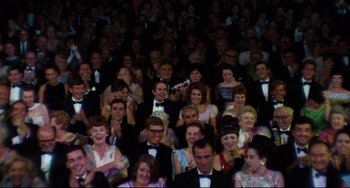 Movie still from “The Producers” (1967), directed by Mel Brooks – A group of people in formal wear are gathered together; Wide shot, High angle