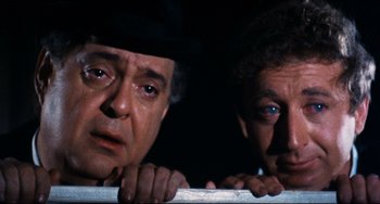 Movie still from “The Producers” (1967), directed by Mel Brooks – Two men looking over a railing in the dark; Close Up shot, Low angle