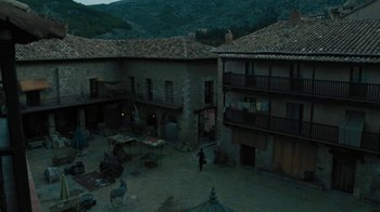Movie still from “The Promise” (2016), directed by Terry George – An aerial view of a courtyard with a horse and rider in the distance; Extreme Wide shot, High angle