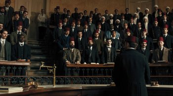 Movie still from “The Promise” (2016), directed by Terry George – A group of men standing in front of each other in suits; Wide shot, High angle