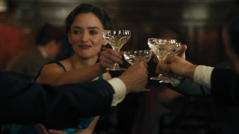 Movie still from “The Promise” (2016), directed by Terry George – A group of people toasting with wine glasses; Close Up shot, Over the shoulder angle