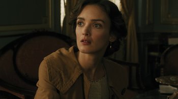 Movie still from “The Promise” (2016), directed by Terry George – A beautiful woman sitting in front of a window; Close Up shot, Over the shoulder angle