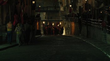 Movie still from “The Promise” (2016), directed by Terry George – A group of people walking down a street at night; Extreme Wide shot, High angle