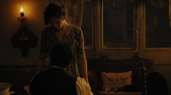 Movie still from “The Promise” (2016), directed by Terry George – A man and a woman standing in front of a window; Medium shot, Over the shoulder angle