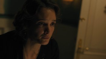 Movie still from “The Promise” (2016), directed by Terry George – A person sitting in a dark room; Close Up shot, Over the shoulder angle