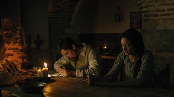 Movie still from “The Promise” (2016), directed by Terry George – A man and a woman sitting at a table with candles; Medium shot, High angle