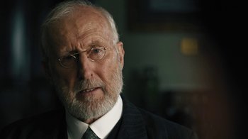 Movie still from “The Promise” (2016), directed by Terry George – An older man wearing a suit and tie; Close Up shot, Over the shoulder angle