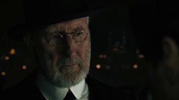 Movie still from “The Promise” (2016), directed by Terry George – An old man with a beard wearing a black hat; Close Up shot, Over the shoulder angle
