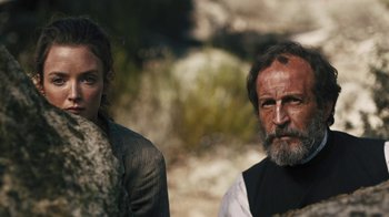 Movie still from “The Promise” (2016), directed by Terry George – A man and a woman standing next to each other; Medium shot, Over the shoulder angle