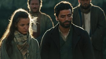 Movie still from “The Promise” (2016), directed by Terry George – A group of people standing next to each other in a field; Medium shot, Low angle