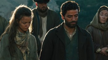 Movie still from “The Promise” (2016), directed by Terry George – A man and a woman are walking in the woods; Medium shot, Low angle