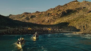 Movie still from “The Promise” (2016), directed by Terry George – A group of people on small boats in the water; Extreme Wide shot, High angle