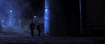 Movie still from “The Punisher” (2004), directed by Jonathan Hensleigh – Two men are walking in the dark at night; Extreme Wide shot, Low angle