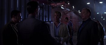 Movie still from “The Punisher” (2004), directed by Jonathan Hensleigh – A man in a suit is talking to another man in a suit; Medium shot, Over the shoulder angle