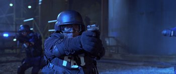 Movie still from “The Punisher” (2004), directed by Jonathan Hensleigh – A man in a swat uniform is holding a gun; Medium shot, Low angle