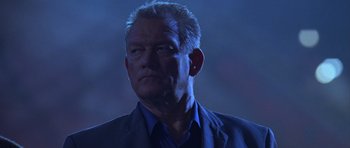 Movie still from “The Punisher” (2004), directed by Jonathan Hensleigh – An older man in a blue shirt and jacket; Close Up shot, Low angle