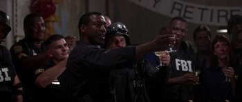 Movie still from “The Punisher” (2004), directed by Jonathan Hensleigh – A group of men standing next to each other holding drinks; Medium shot, Low angle