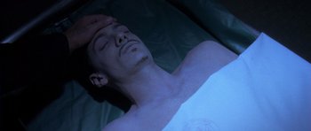 Movie still from “The Punisher” (2004), directed by Jonathan Hensleigh – A man laying on a bed in a dark room; Close Up shot, High angle