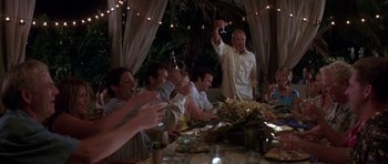 Movie still from “The Punisher” (2004), directed by Jonathan Hensleigh – A group of people sitting at a table with food and drinks; Wide shot, Low angle