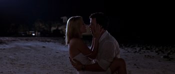 Movie still from “The Punisher” (2004), directed by Jonathan Hensleigh – A man and a woman embracing on the beach at night; Medium shot, Low angle