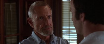 Movie still from “The Punisher” (2004), directed by Jonathan Hensleigh – An older man with a gray beard is talking to a younger man; Close Up shot, Over the shoulder angle