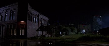 Movie still from “The Punisher” (2004), directed by Jonathan Hensleigh – A building that has been lit up at night; Extreme Wide shot, Low angle