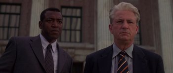 Movie still from “The Punisher” (2004), directed by Jonathan Hensleigh – Two men in suits and ties standing next to each other; Close Up shot, Low angle