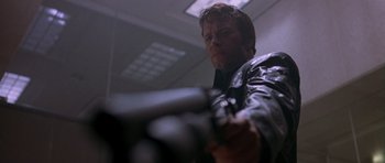 Movie still from “The Punisher” (2004), directed by Jonathan Hensleigh – A man in a black jacket holding a gun; Close Up shot, Low angle