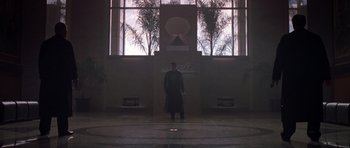 Movie still from “The Punisher” (2004), directed by Jonathan Hensleigh – A man standing in front of a window in a building; Extreme Wide shot, Low angle