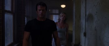 Movie still from “The Punisher” (2004), directed by Jonathan Hensleigh – A man and a woman walking in a dark hallway; Medium shot, Low angle