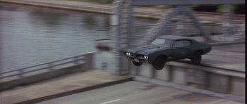 Movie still from “The Punisher” (2004), directed by Jonathan Hensleigh – A car flying through the air over a bridge; Wide shot, High angle