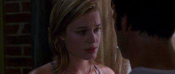 Movie still from “The Punisher” (2004), directed by Jonathan Hensleigh – A young woman looking at the camera while talking to a man; Close Up shot, Over the shoulder angle